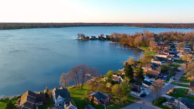 Waterfront residential houses aerial view in the morning on Walled Lake in city of Walled Lake, Michigan MI, USA. 