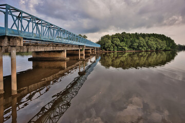 Fototapeta premium Dramatic sky above a steel bridge in Pekan, Pahang, Malaysia
