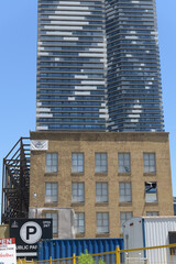 Obraz premium (brick building) former LCBO headquarters at 55 Lake Shore Blvd E and view of Sugar Wharf condominium complex towers, Toronto