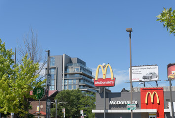 Obraz premium distant view of McDonald's Canada Golden Arches street sign with soccer ball at 710 St Clair Av W, Toronto