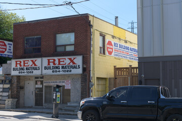 Obraz premium exterior building facade and sign of Rex Building, a building materials supplier, located at 405 Rogers Rd, Toronto