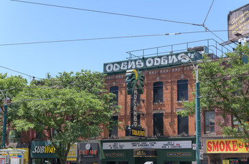 Obraz premium wide distant view of building facades and signs including El Mocambo a live music venue located at 464 Spadina Av, Toronto