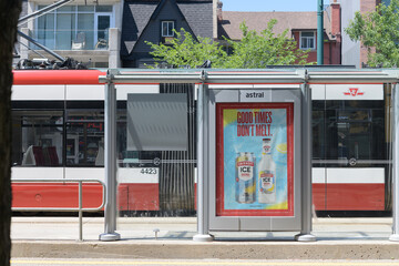 Obraz premium defocused trolley and transit shelter advertising for Smirnoff Ice (by Diageo) on Spadina Av, Toronto