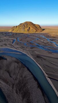 Vertical Aerial Shot Approaching Volcanic Hill Over River Plain in Stora Dimon, Iceland