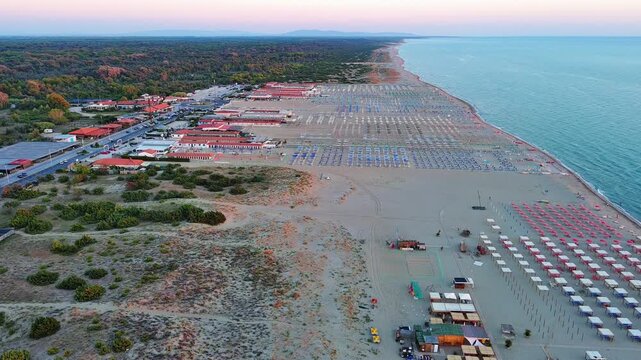Drone Shot of Italian Beach Resort with Umbrellas and Sea at Dusk