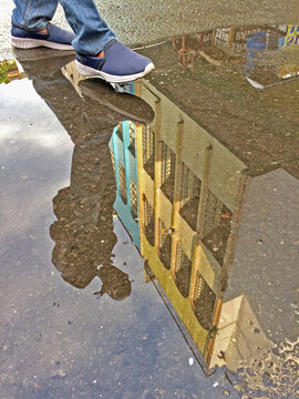 Reflection of a building in a puddle on the street
