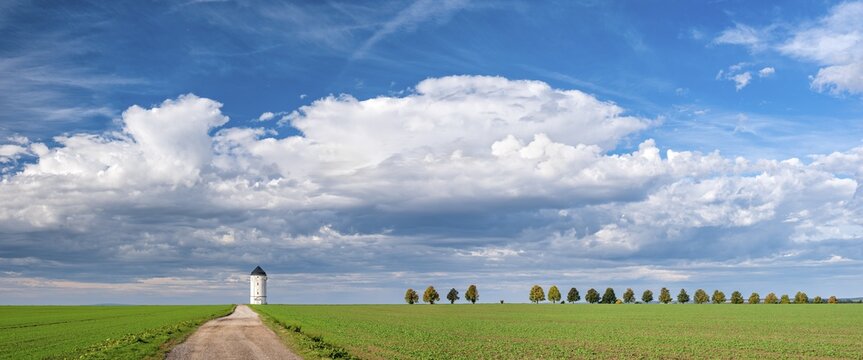 Field path leading to the water tower Cr&ouml;lpa-L&ouml;bsch&uuml;tz, field landscape under cloudy sky, near Naumburg, Saxony-Anhalt, Germany