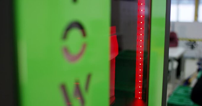 Hand of a worker pressing buttons on a numeric keypad and turning a handle to open a secure safe