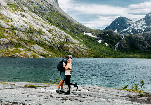 Couple hugging in love enjoying vacations in Norway travel hiking together man and woman on summer romantic holidays tour in Aselidalen, happy family lifestyle relationship bonding candid emotions