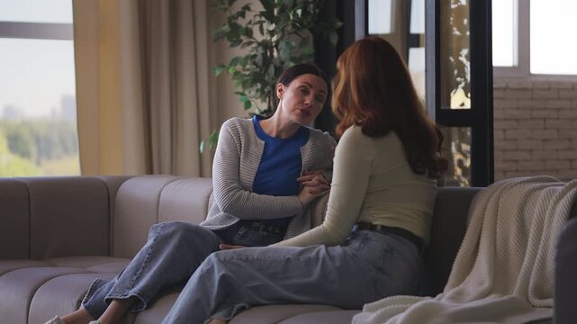 Woman sharing good news with her excited female friend, trusting relationship