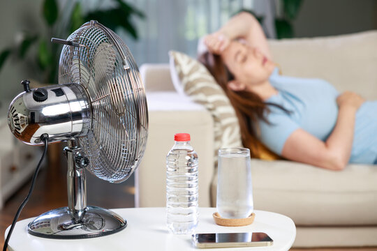 Electric fan with water and smartphone during heatwave
