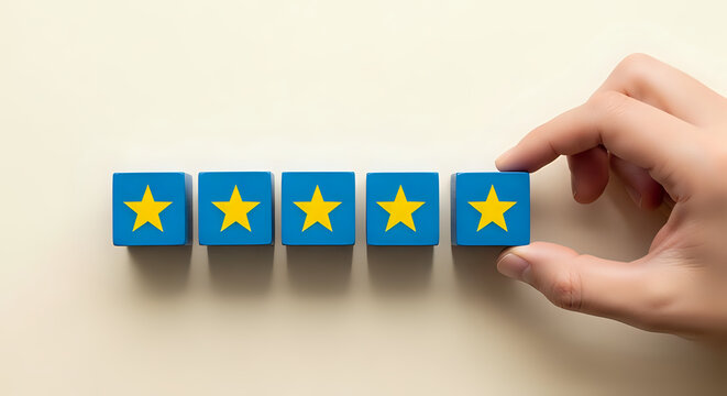 Customer experience rating with five yellow stars on blue wooden blocks held by a hand feedback customer