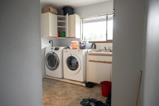 Laundry room with washing machines and utility sink