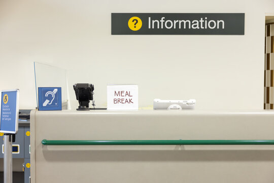 Empty information desk at airport terminal on meal break