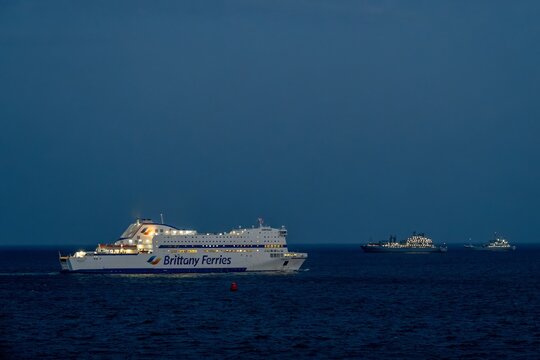 Plymouth England - June 22 2026: Brittany Ferries Armorique in Plymouth Sound Devon at night with lights reflecting in the sea