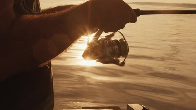Angler stands in the boat and fishing on the lake