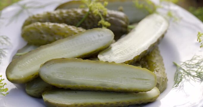 Traditional pickled cucumbers, pickled using the natural fermentation method, on a plate, close-up view