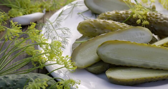 Traditional pickled cucumbers, pickled using the natural fermentation method, on a plate, close-up view