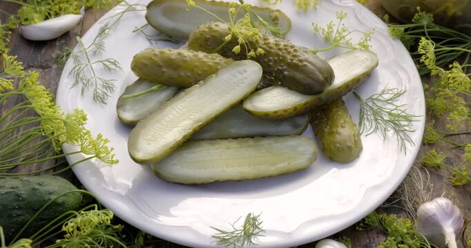Traditional pickled cucumbers, pickled using the natural fermentation method, on a plate, close-up view