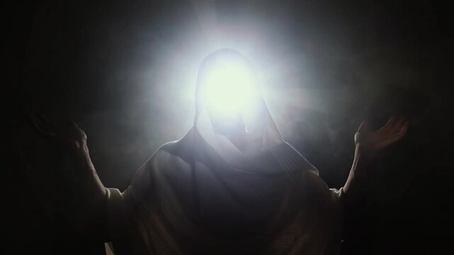 Divine Radiance: A figure shrouded in light with arms outstretched in supplication or prayer, embodying spiritual enlightenment and connection.
