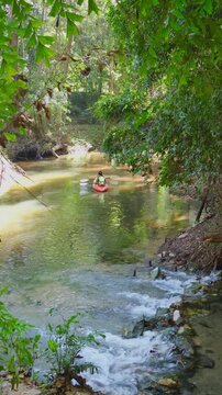 A wonderful day of ecotourism with two people kayaking in tropical rainforest river