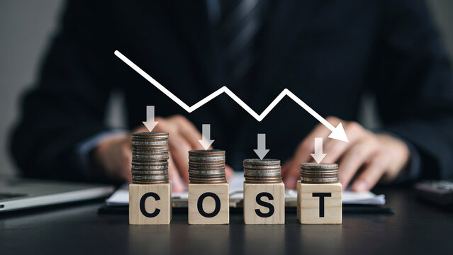 Cost Wooden Blocks with Declining Coin Stacks and Downward Arrow Chart, Reduction Concept