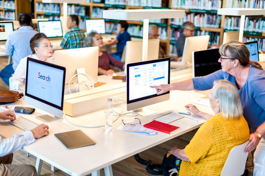 Senior adults learning computer skills