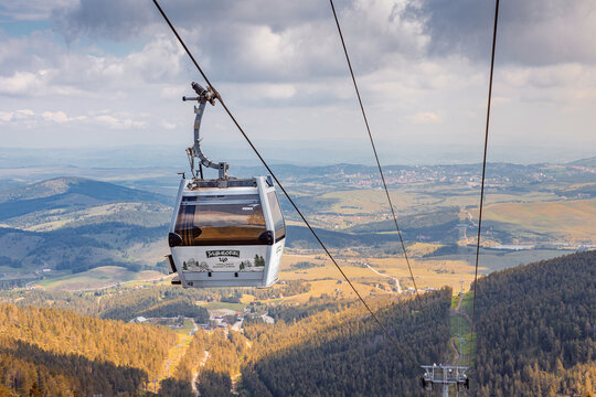 21 May 2026, Zlatibor, Serbia: Gold Gondola cable car cabin gliding over green pine forest, offering panoramic views of Serbian mountain landscape from Tornik peak