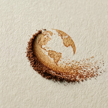 Abstract Earth globe made of brown powder on textured paper