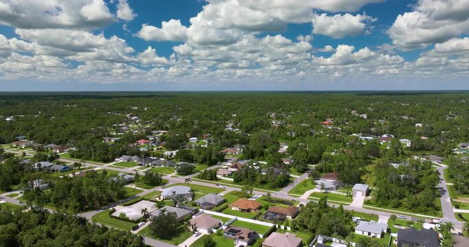 Suburban housing development with rows of modern houses and clean streets, illustrating suburban planning, population growth and middle class residential environment.