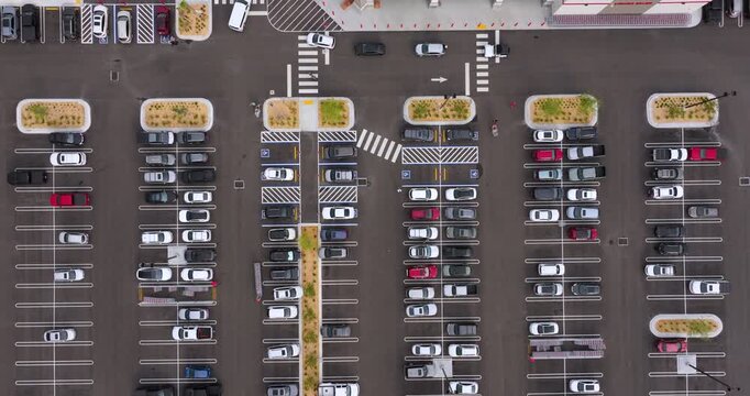 Suburban shopping plaza with parking rows and crowded car spaces. Weekend rush, retail activity and community lifestyle concept.