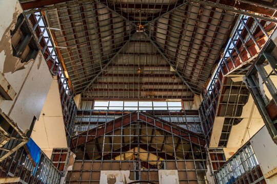 View of the interior of the damaged San Jose Catholic Church with exposed metal framing and structural beams in San Jose, Tinian, Northern Mariana Islands.