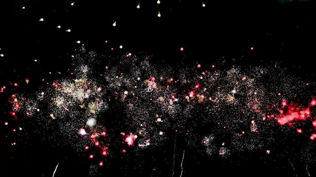 4K. loop seamless of real fireworks background golden shining fireworks with bokeh lights in the night sky. glowing fireworks show. New year's eve fireworks celebration multiple colors