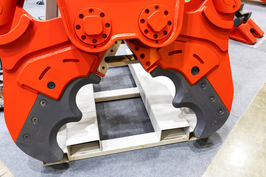 Large red drill head used in the rock drilling and mining industry.