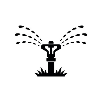 Black silhouette of a garden sprinkler spraying water on grass