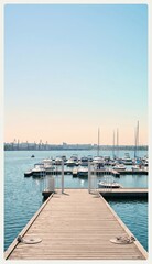 Fototapeta premium Marina entrance gate and dock leading to moored yachts on a sunny day