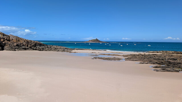Saint-Michel Beach with the Chapel of Saint-Michel in the Distance and Ilot du Verdelet Tidal Island in Erquy, Brittany, France. 