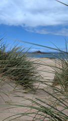 Obraz premium Distant view of Ilot Saint-Michel and chapel from the coastal landscape of Erquy, Brittany, France. 