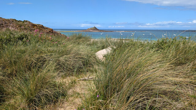 Ilot Saint-Michel at low tide with Chapel of Saint-Michel in the distance, Erquy, Brittany, France.
