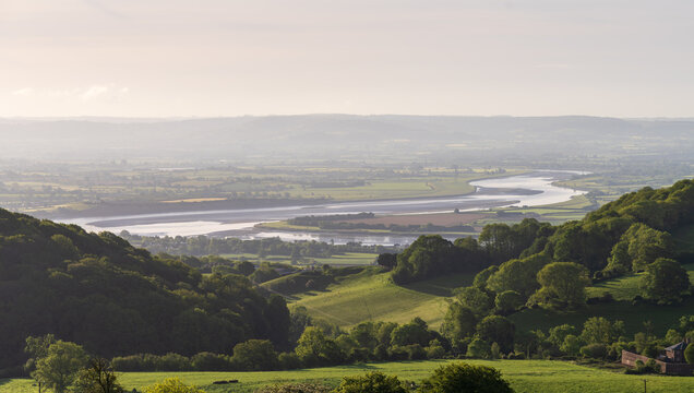 Panorama of green landscape with the Severn River valley under a blue sky in Gloucestershire seen from hilltop town of Cinderford