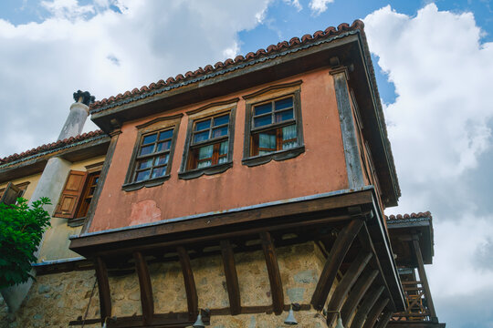 View of traditional Macedonian architecture with a stone base and wooden balcony in Arnaia, Halkidiki, Greece.