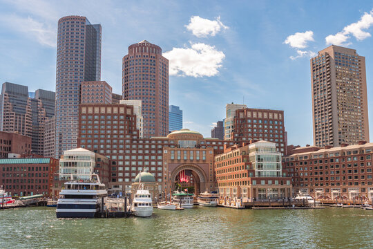Boston, MA, US-June 8, 2026: Boston Skyline viewed from Boston Harbor with skyscrapers, Rowe's Wharf and boats.