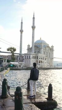 Man Exploring Ortakoy Mosque on Istanbul Waterfront