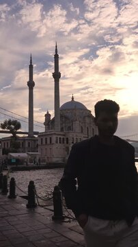 Traveler Walking Ortakoy Mosque During Golden Hour in Istanbul