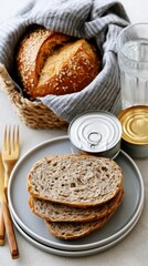 Naklejka premium A top-down view shows a basket of bread, a glass of water, and a can on a large, clean table to depict a survival lifestyle