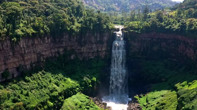 Aerial view of Tequendama Falls in Colombia, a majestic waterfall surrounded by lush green forest and rocky cliffs