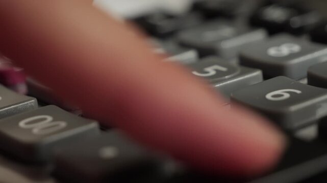 Close up of calculator on a desk, person creating a financial budget, calculating taxes. High quality 4k footage