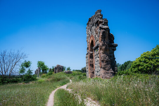 Ruins of ancient Roman aqueduct in Parco degli Acquedotti against blue sky