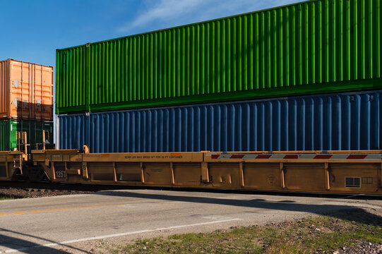 Train Loaded with Shipping Containers Passes Over Intersection