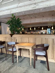 Fotobehang Horeca Cozy modern cafe interior with wooden furniture and warm lighting  © Igor